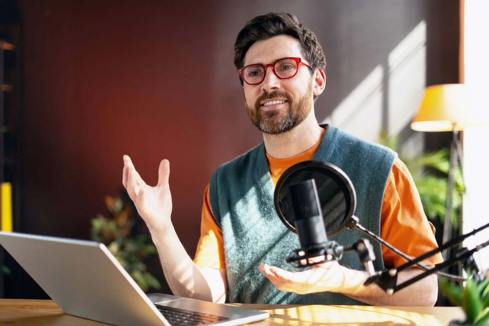 A man who has undergone a content creator apprenticeship, currently working on a new podcast episode for the business.